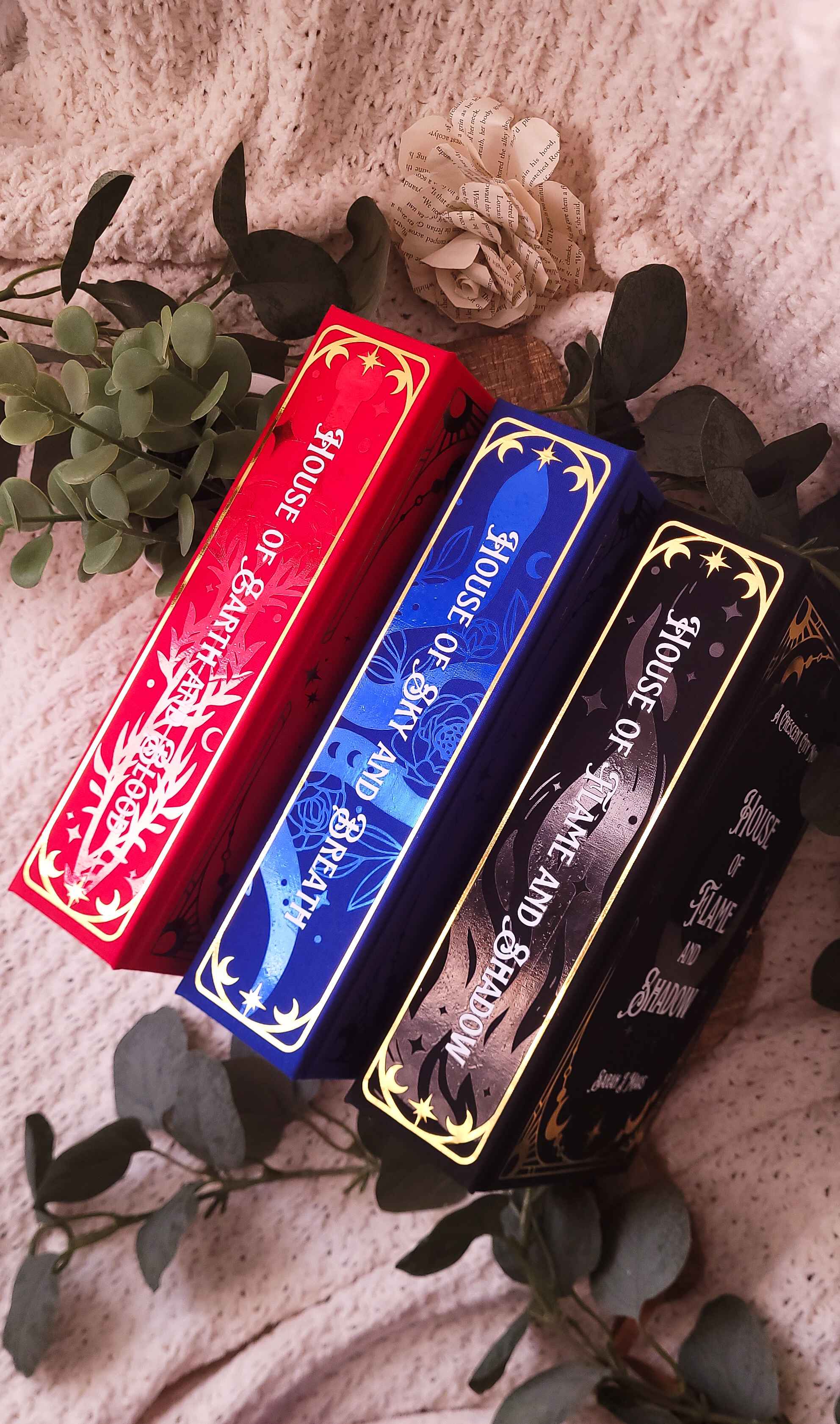 Hand-rebound Crescent City book set in red, blue, and black bookcloth with gold and holographic accents