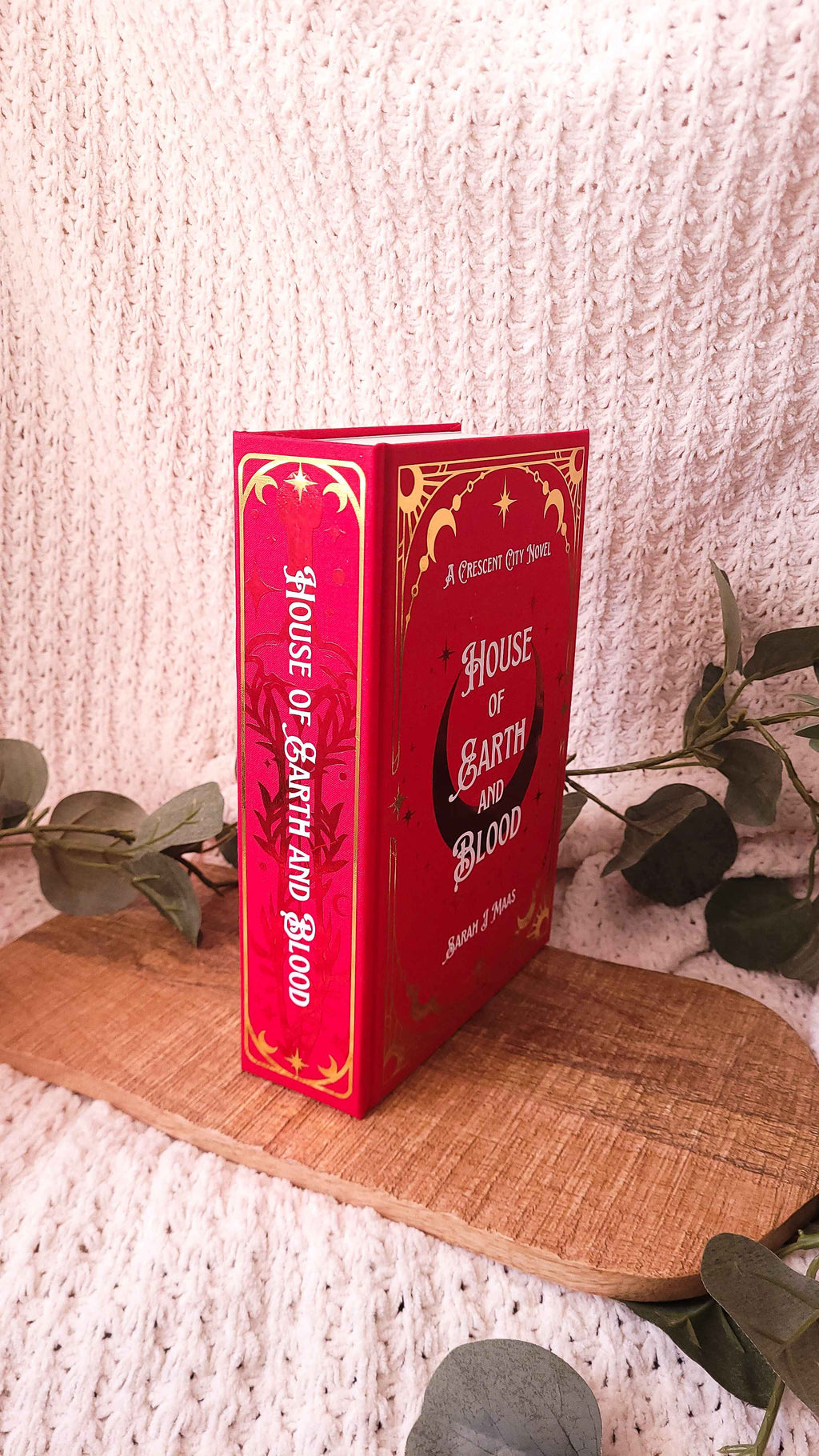 Handmade rebound of House of Earth and Blood in red bookcloth with red, white, and gold accents